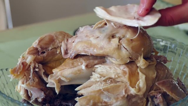 A woman takes off his boiled chicken meat,boiled whole chicken, boiled chicken meat, boiled chicken breast meat,
