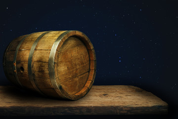 Wooden barrel and worn old table of wood.