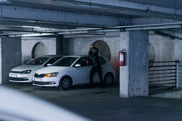 Assaulter breaking a car with pry bar