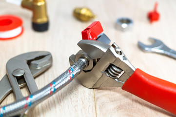 Plumbing tools and spare parts on the table.