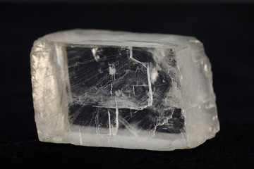 Raw Iceland spar from Krasnoyarsk region, Russia on black cement background.