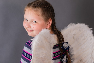 Strong stout smiling angel girl with wings.