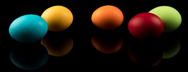 Easter Eggs Banner. Colorful Easter Eggs on black background with reflection. Modern Design.