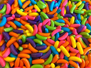 top view flat lay background of Colorful sweet bright candy pieces shaped like bananas, close up background