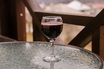 A glass of red wine on table