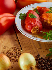 Stuffed peppers: rice with meat and spices in tomato sauce - delicious food.