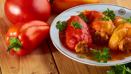 Stuffed peppers: rice with meat and spices in tomato sauce - delicious food.