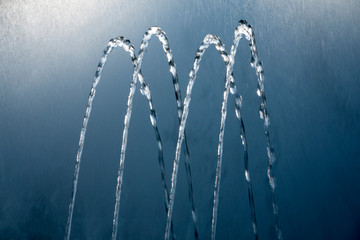 Four water jets from a fountain. Abstract image.