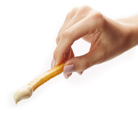 French fries held in fingers isolated on white background