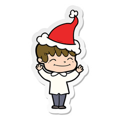 sticker cartoon of a happy boy wearing santa hat