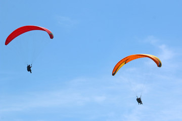 Paragliders flying in a blue sky