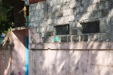 A couple of rectangular windows in a brick wall (Ari Atoll, Maldives)