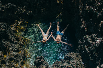 Man and woman together swim in the pool