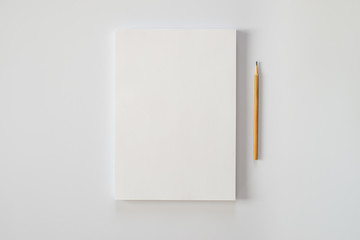 A stack of blank sheets of paper and a pencil on a white background - Powered by Adobe