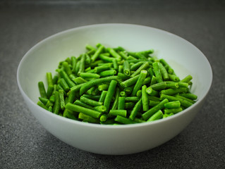 Green beans in a white bowl.