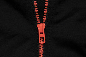 bright orange zipper on on black fabric