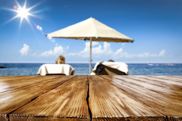 Desk of free space and beach landscape with sun on blue sky 