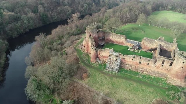 Aerial footage of Bothwell Castle near Uddingston in Scotland. Dramatic location by a winding curve in the River Clyde.