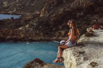 Couple embrace and sitting on the coastline