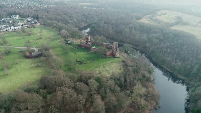 Aerial footage of Bothwell Castle near Uddingston in Scotland. Dramatic location by a winding curve in the River Clyde.