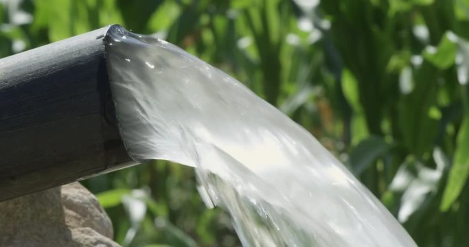 Cloudy water flowing out of a hard rubber pipe