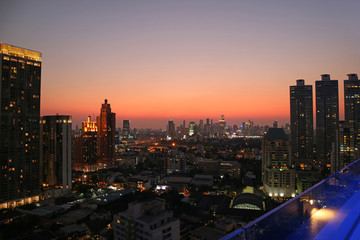 Naklejka premium Oszałamiający panoramiczny widok na centrum Bangkoku z kolorowym niebem zachodzącego słońca w tle