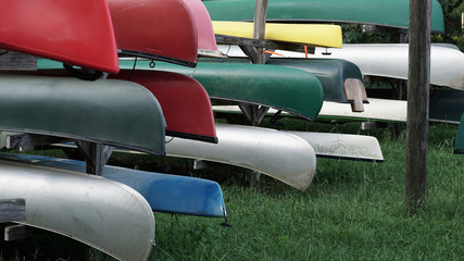 Colorful canoes in stored in dry dock