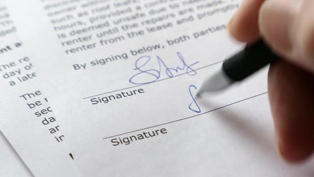 The Man Signs The Document With His Signature. Slider Shot. Fake signature. Fake Document. 