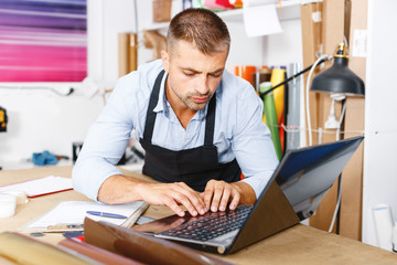 Fototapeta premium portrait of working advertising agency behind a laptop