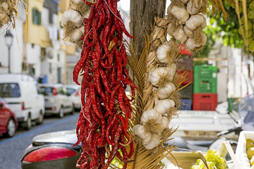Bunches of chilli peppers hanging at the market.