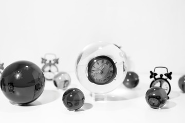 Time abstraction. Glass balls with clock reflections