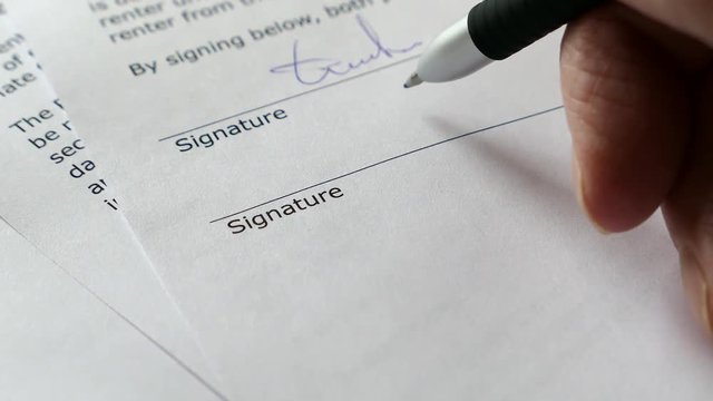 The Man Signs The Document With His Signature. Slider Shot. Fake signature. Fake Document. 