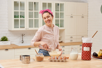 Portrait of beautiful young woman having breakfast in the kitchen