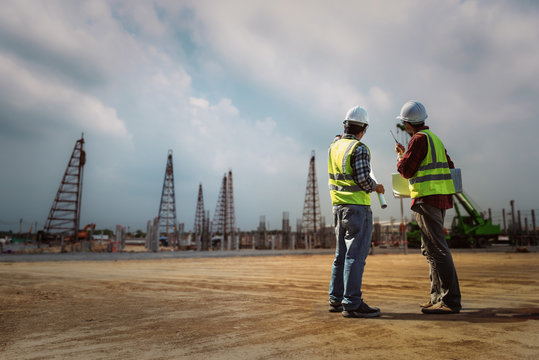 Construction engineers discussion with architects at construction site or building site. Consultant in construction site jobs concept.