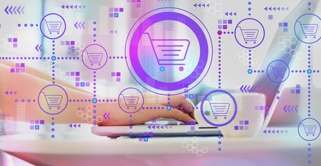 Online shopping theme with woman using a laptop on a coffee table 