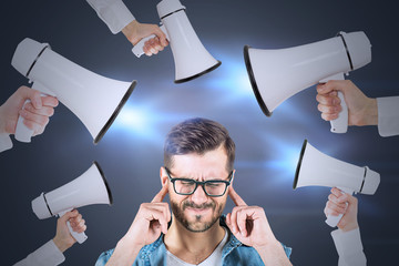 Man covering ears, hands with megaphones