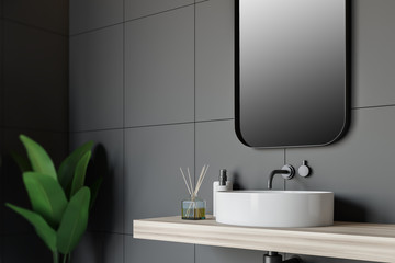 Side view of gray tile bathroom with sink