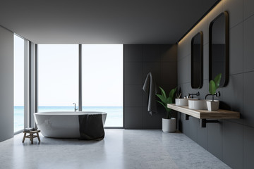 Gray tile bathroom interior, tub and sinks