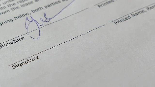The Man Signs The Document With His Signature. Slider Shot. Fake signature. Fake Document. 