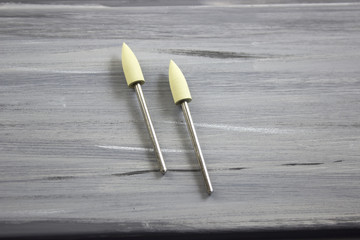 Cutters for milling machine for manicure close-up. Professional tool. Hardware manicure. Gray background.