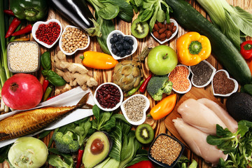 Healthy food clean eating selection. fruit, vegetable, seeds, superfood, cereals, leaf vegetable on rustic background