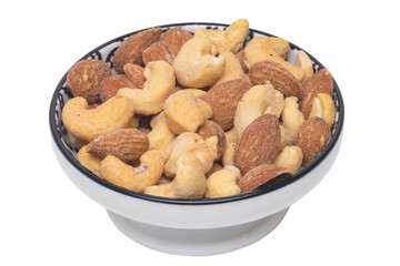 Nuts background. Close-up of roasted and salted almonds and cashew nuts in a ceramic bowl isolated on a white background. Gourmet nut mix with almonds. Macro.