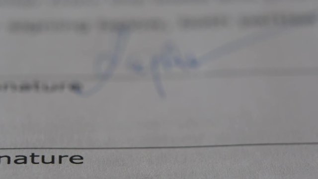 The Man Signs The Document With His Signature. Slider Shot. Fake signature. Fake Document. 