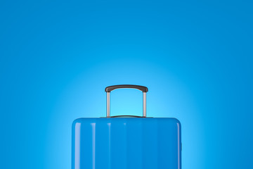 Blue suitcase close up over blue