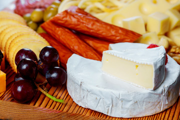 Cheese plate served with crackers, assorted cheeses