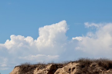 clouds on blue sky over cliff