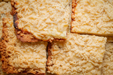 Freshly baked sand cake cut into pieces lie on top of each other