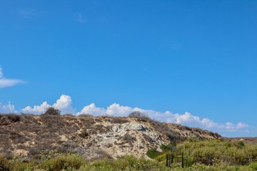 Fototapeta na wymiar clouds on blue sky over cliff