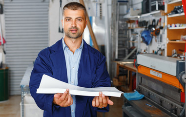 portrait of a working man at printer studio