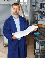 portrait of a working man at printer studio